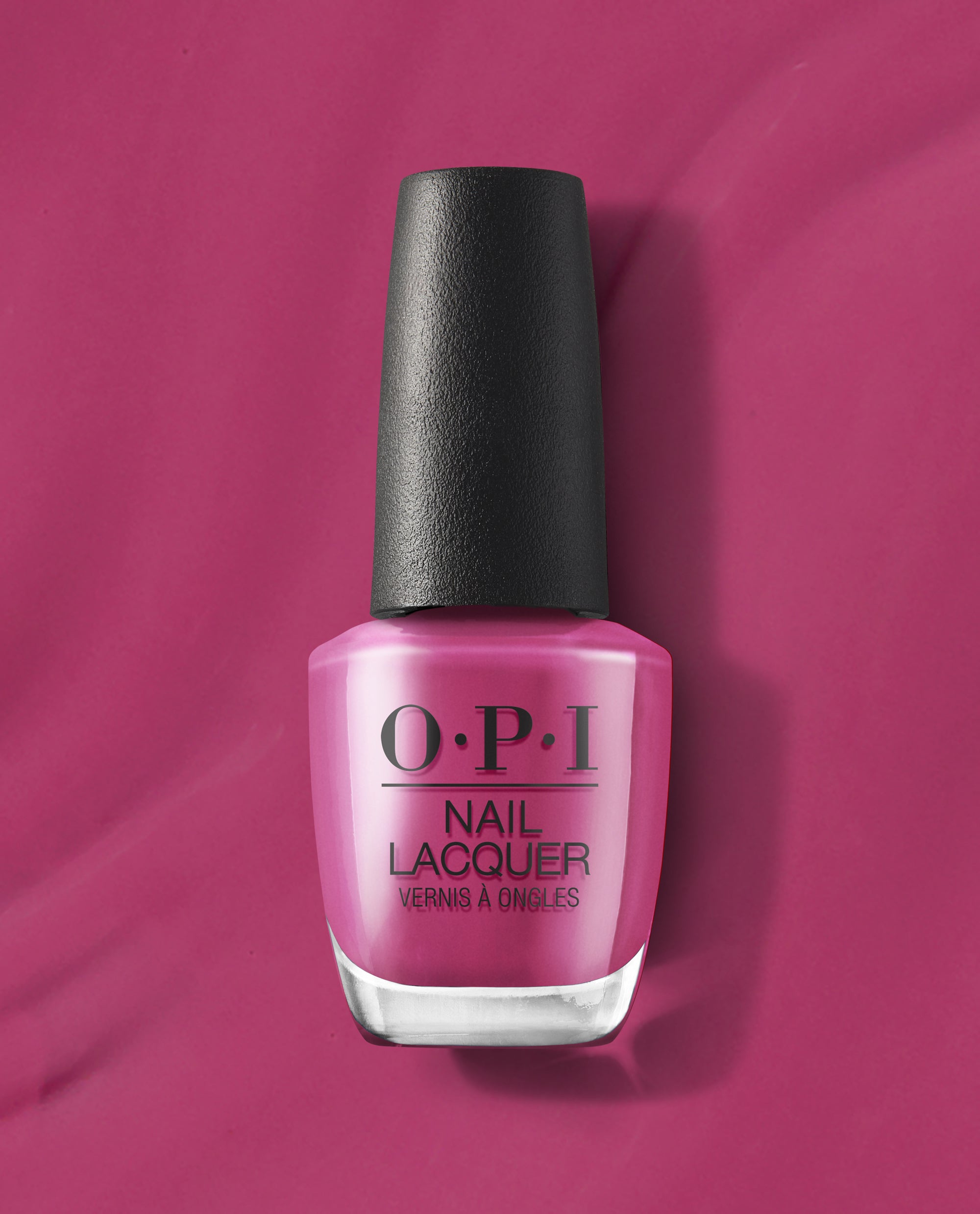 7th & Flower OPI nail polish bottle standing upright, showcasing rich magenta pink nail lacquer with a black cap against a matching glossy pink background, highlighting the vibrant salon-quality nail color for manicures and pedicures.