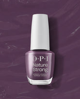 OPI Nature Strong Vegan Nail Lacquer in Eco-Maniac, a muted plum-purple fall nail color, stands upright with a white cap against a glossy purple polish-swipe background.