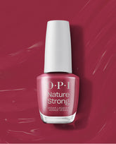 OPI Give a Garnet Nature Strong Vegan Nail Lacquer bottle in a rich garnet berry shade with a white cap, shown on a glossy matching swatch background for fall nail colors.