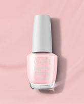 OPI Let Nature Take Its Quartz Nature Strong vegan nail lacquer bottle in a sheer pale pink shade with a white cap, centered on a soft pink background.