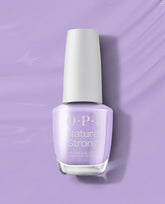 OPI Nature Strong Vegan Nail Lacquer in Spring Into Action displays a soft lavender shade in a glass bottle with a white cap on a matching purple background, a fresh option for fall nail colors.