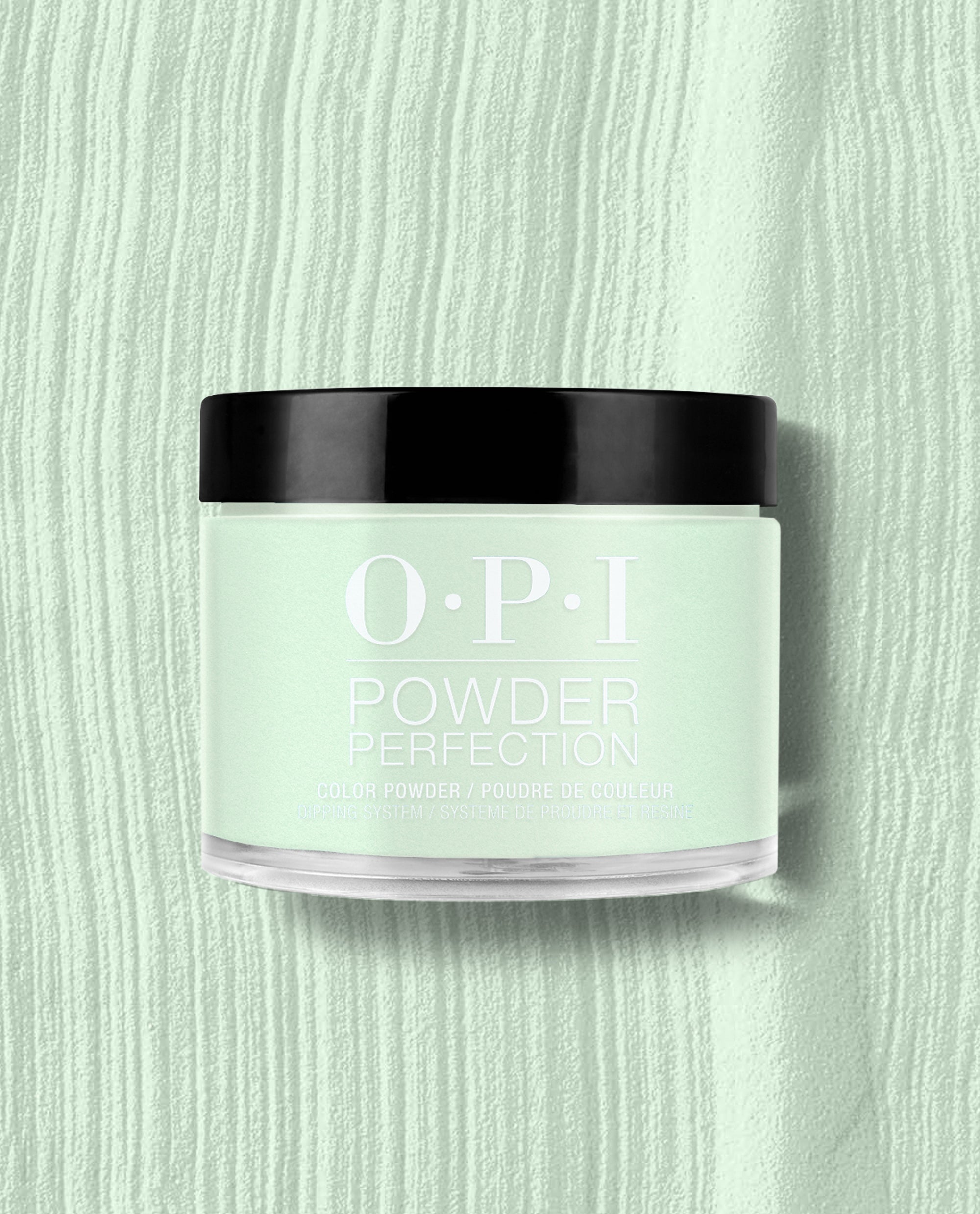 OPI AppointMINT Confirmed Powder Perfection dipping powder in a clear jar with black lid sits centered on a textured pastel mint background, showcasing green nail polish ideal for spring nail colors with prominent OPI branding.
