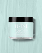 OPI Powder Perfection Reality Check Ya Out dipping powder showcases a soft mint green shade, delivering a green nail polish look ideal for spring nail colors, displayed in a clear jar with black lid on a matching textured pastel backdrop.
