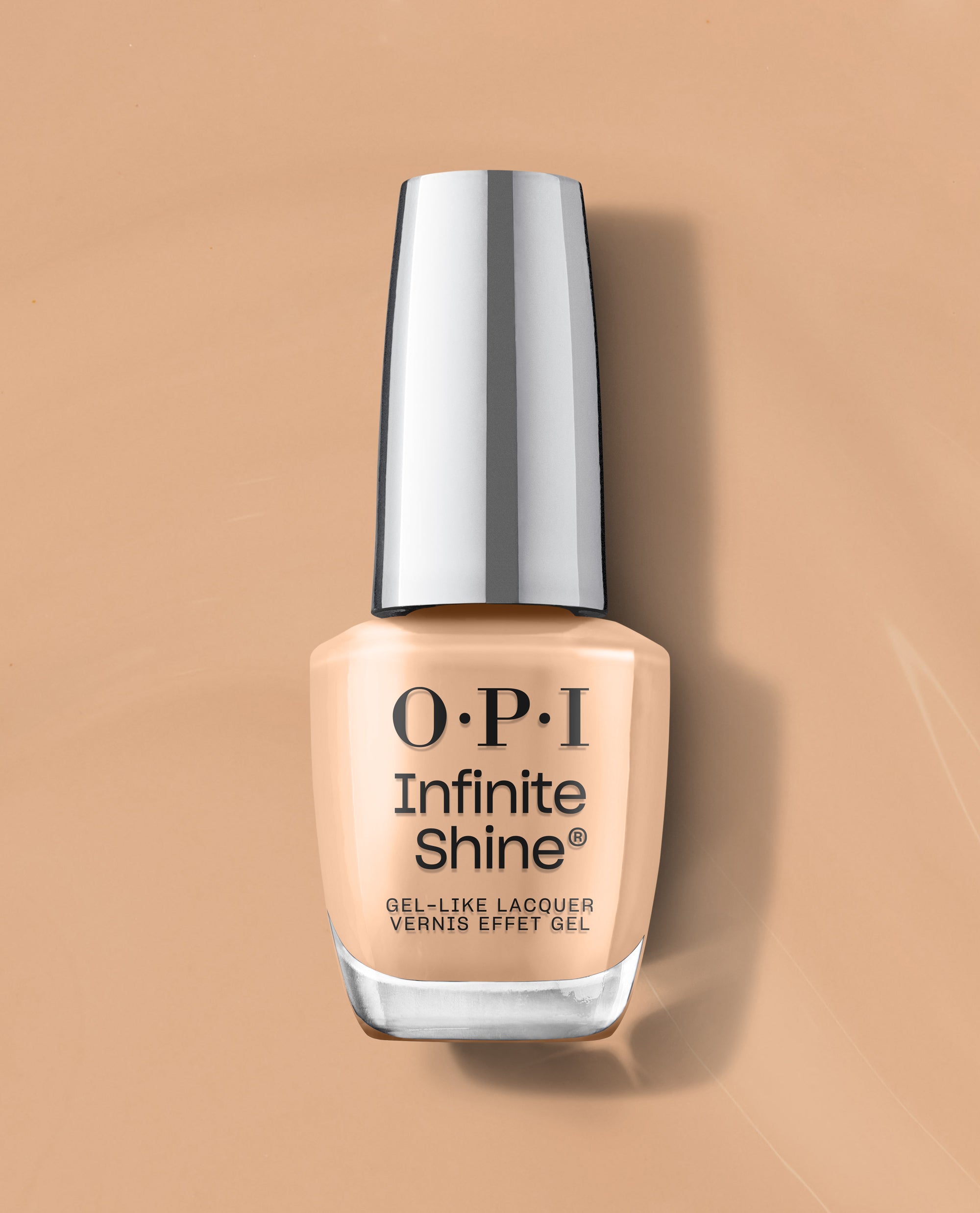 OPI nail polish bottle of A Total Suzi Infinite Shine gel-like lacquer standing upright on a matching beige background, showcasing its creamy nude shade and sleek silver cap for a modern, long-wear manicure look.