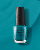 OPI AmazON...AmazOFF Nail Lacquer bottle stands upright, showcasing a rich teal-green shade on a matching backdrop—green nail polish from OPI, a bold pick for spring nail colors.