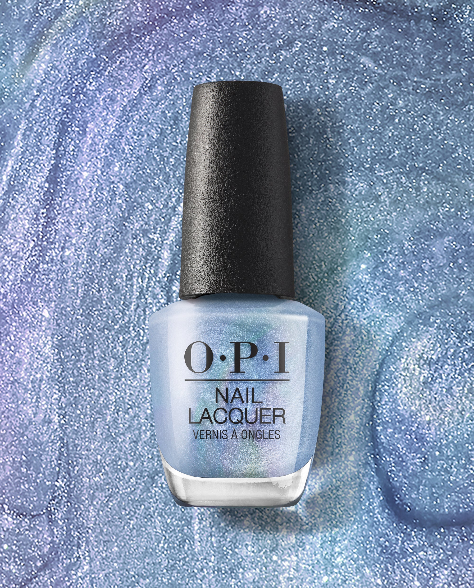 OPI nail polish Angels Flight to Starry Nights nail lacquer bottle standing upright, showcasing its iridescent icy blue shimmer shade against a close-up background of the same sparkling, glittery polish.