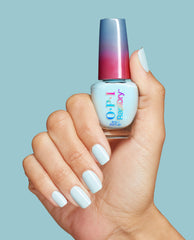 Hand with glossy baby blue manicure holds an OPI RapiDry Baby Blue Me Away nail lacquer bottle against a matching light blue background.