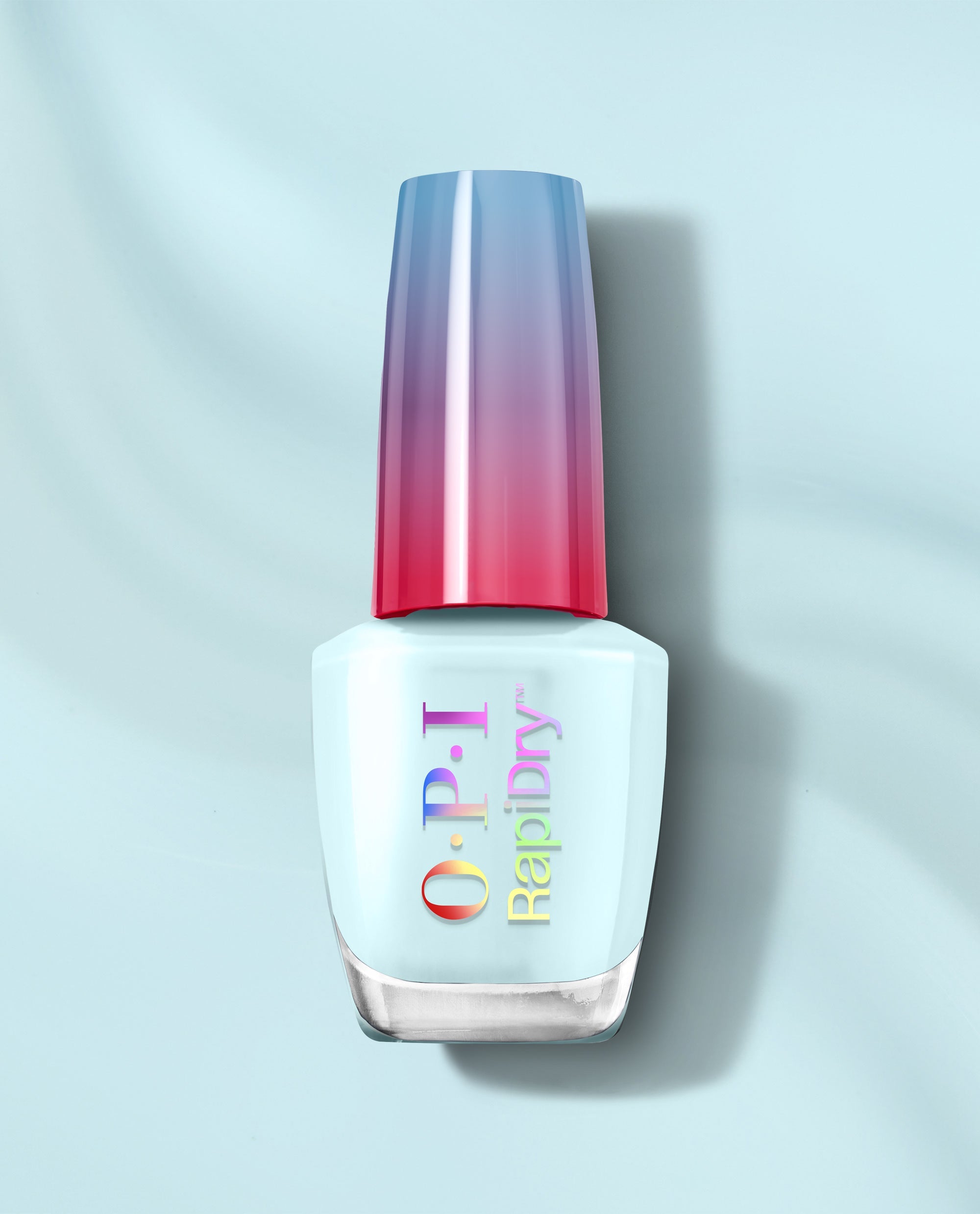 OPI RapiDry Baby Blue Me Away nail polish bottle in pale baby blue with a glossy blue-to-pink gradient cap on a light blue background.
