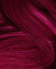 Big Sagittarius Energy nail lacquer swirled in close-up, showing deep magenta OPI nail polish with fine glitter shimmer and smooth, glossy texture across the frame.