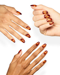 Hands show OPI Burn After Glazing xPRESS/ON nails in glossy burgundy and metallic copper swirls, a dramatic set of fall nail colors on a clean white background.