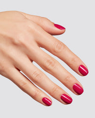 Hand with neatly manicured nails painted in a glossy bright berry pink shade, showcasing the Clawberry Margarita at-home gel nail polish, ideal as an OPI-inspired nail polish gift set option, against a clean light gray background.