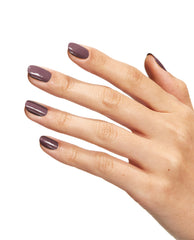Hand with neatly manicured nails painted in Claydreaming, a taupe-mauve OPI nail polish nail lacquer, shown against a clean white background to highlight the smooth, glossy finish and muted neutral color for everyday wear.
