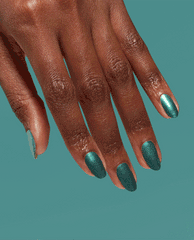 Hand with medium-long oval nails showcases OPI nail polish Cos-mo Money Infinite Shine, a shimmery teal green shade, against a matching teal background, highlighting the bold metallic manicure color for US shoppers.