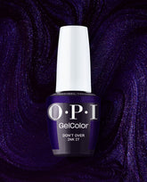 OPI Don’t Over Ink It GelColor gel nail polish bottle stands against a sparkling deep purple swirled backdrop, showcasing a rich violet shimmer shade for fall nail colors.