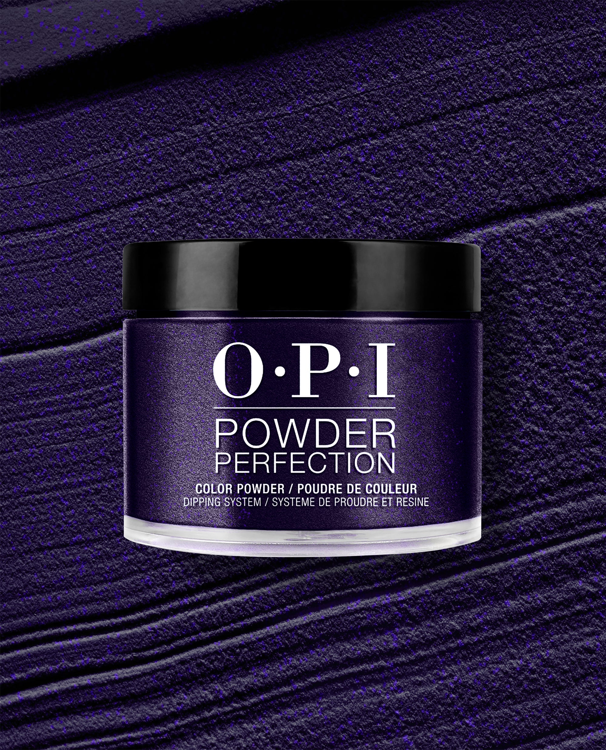 OPI Powder Perfection Don't Over Ink It dipping powder jar displays a deep shimmering purple shade against a textured powder swatch, a bold choice for fall nail colors.