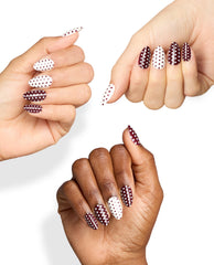 Dotticure On Point manicure shows almond nails in burgundy and white polka dots on three hands, highlighting OPI fall nail colors against a clean white background.
