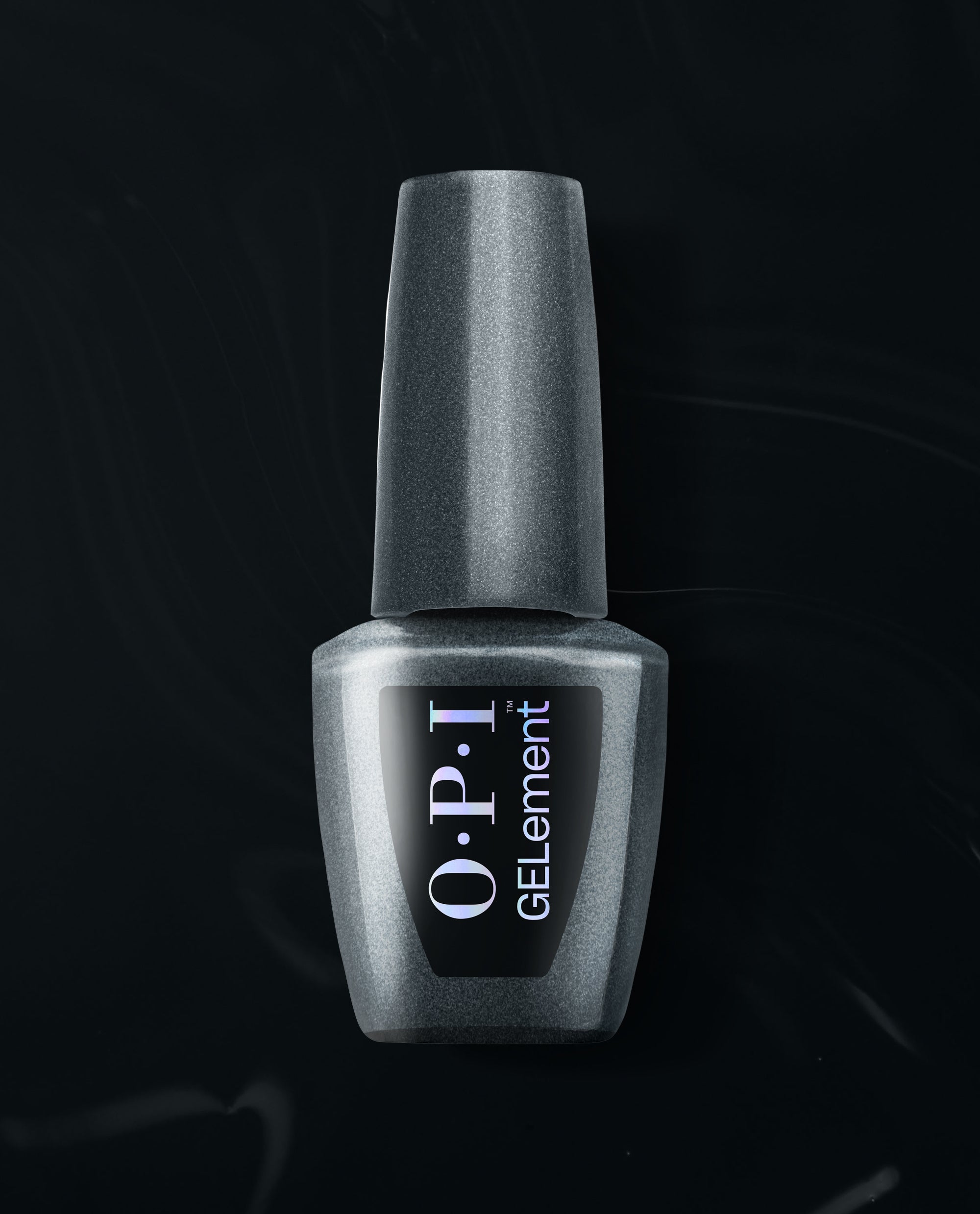 OPI EMOtional at-home gel nail polish bottle in metallic charcoal shimmer stands upright on a black satin background, a trending shade for salon-style manicures at home.