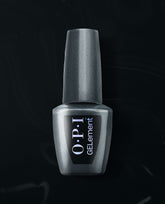 OPI EMOtional at-home gel nail polish bottle in metallic charcoal shimmer stands upright on a black satin background, a trending shade for salon-style manicures at home.