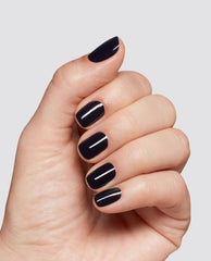 Hand displays glossy deep black-purple EMOtional at-home gel nail polish on short rounded-square nails, a trending OPI manicure shade against a clean light gray background.