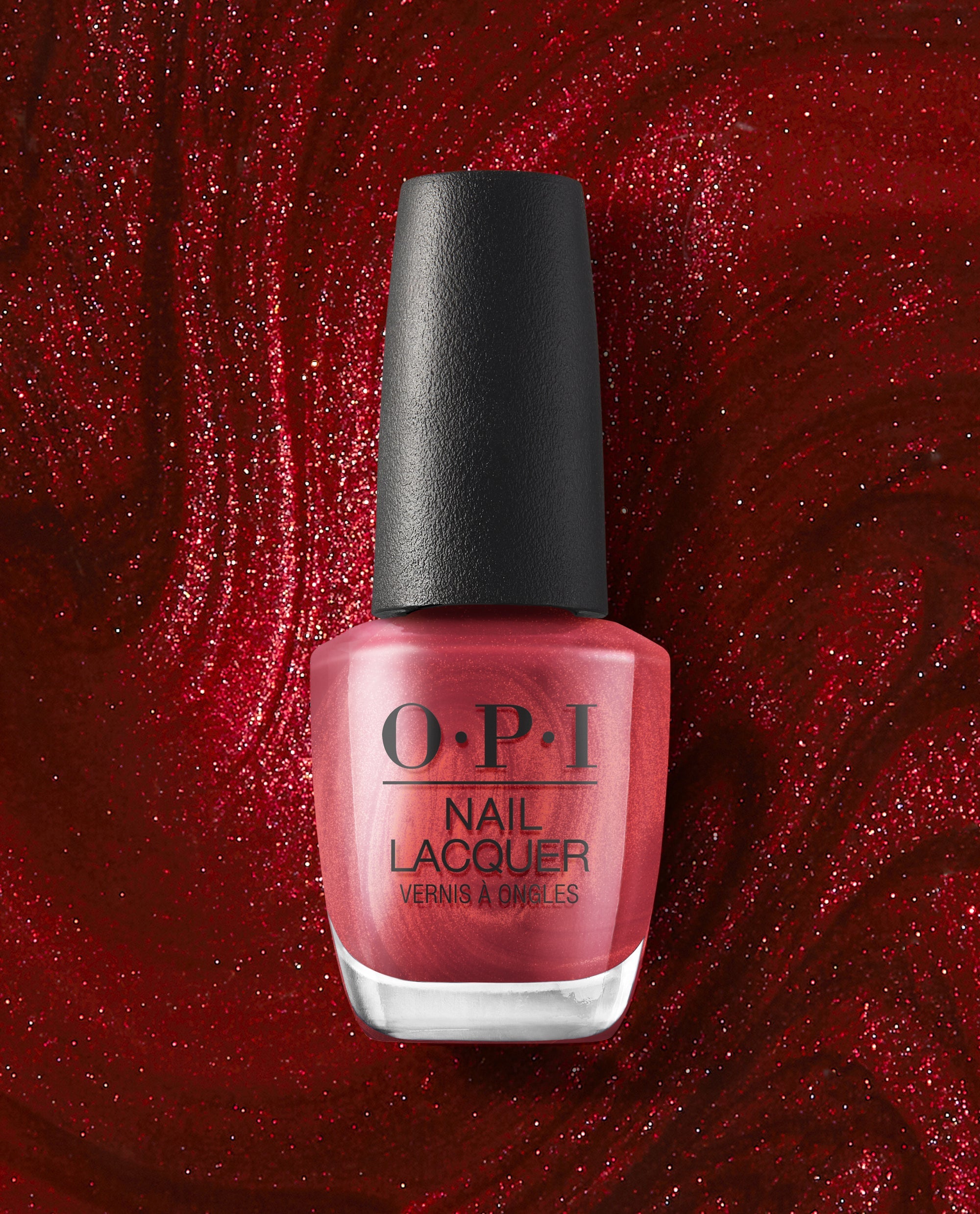 OPI nail polish bottle of CD Rom-antic nail lacquer standing upright, showcasing its shimmery metallic red shade against a swirling, glittery deep red background for a bold, glamorous manicure look.