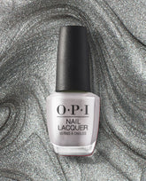 OPI nail polish bottle of Chrome Clawz nail lacquer standing upright, showcasing a metallic silver chrome shade against a swirling, glittery silver background for a bold, futuristic manicure look.