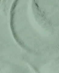 Feelin’ Capricorn-y dipping powder swatch—pastel sage green with fine iridescent glitter—loose powder forming soft ripples on a flat surface, perfect for green nail polish looks and trending spring nail colors from OPI.