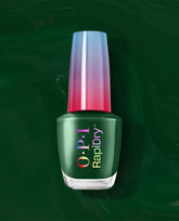 OPI RapiDry Fir Surely Fast green nail polish bottle stands upright with an iridescent pink-blue cap on a glossy dark green swirled background.