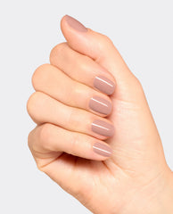 Hand displays glossy taupe-mauve nails with OPI France-y Seeing You Here dipping powder, a soft neutral choice for fall nail colors on a clean light gray background.