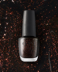 OPI nail polish Grunge Queen nail lacquer bottle standing upright, showing a deep black base packed with copper and red glitter, set against a matching sparkling black-and-bronze glitter background for a dramatic, edgy manicure look.