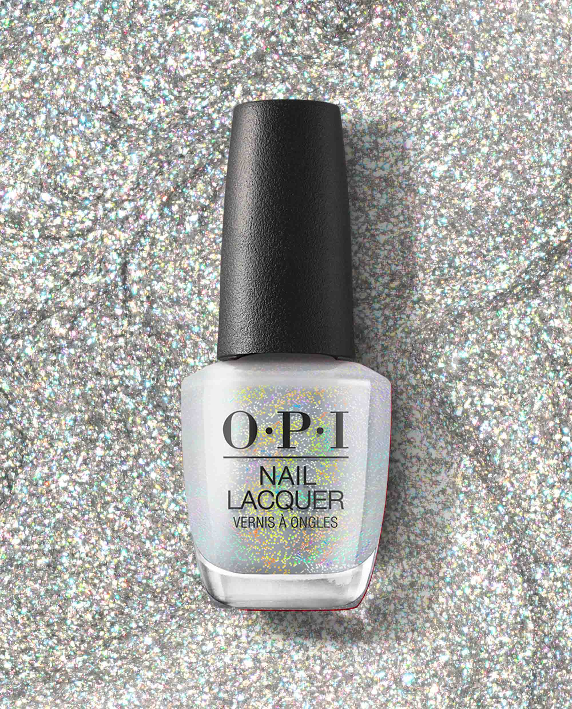 OPI nail polish bottle of I Cancer-tainly Shine nail lacquer standing upright on a sparkling silver glitter background, showcasing its iridescent white shimmer finish for manicures and pedicures.