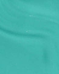 OPI I’m Yacht Leaving nail lacquer swatch flowing in glossy brush strokes, showcasing a bright aqua-teal green nail polish ideal for spring nail colors on a smooth surface with subtle ripples and shine.