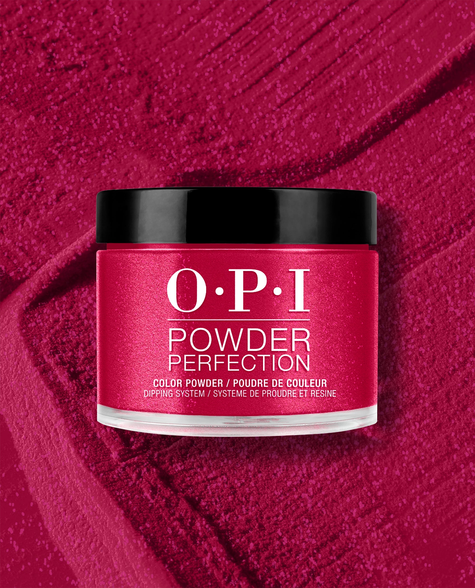 OPI It’s All Greek to Me dipping powder jar with black lid in a rich shimmery magenta shade, displayed on a matching textured powder background for bold fall nail colors.