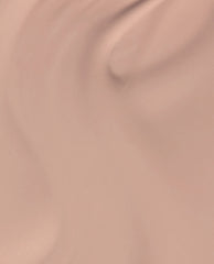 Just Got Leid at-home gel nail polish swatch shows a glossy soft nude pink-beige shade, an OPI fall nail color, spread smoothly across a close-up lacquer surface.