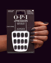 OPI xPRESS/ON Lincoln Park After Dark press-on nails in deep black-plum, shown on a hand beside the 14-day wear package, a dramatic choice for fall nail colors.