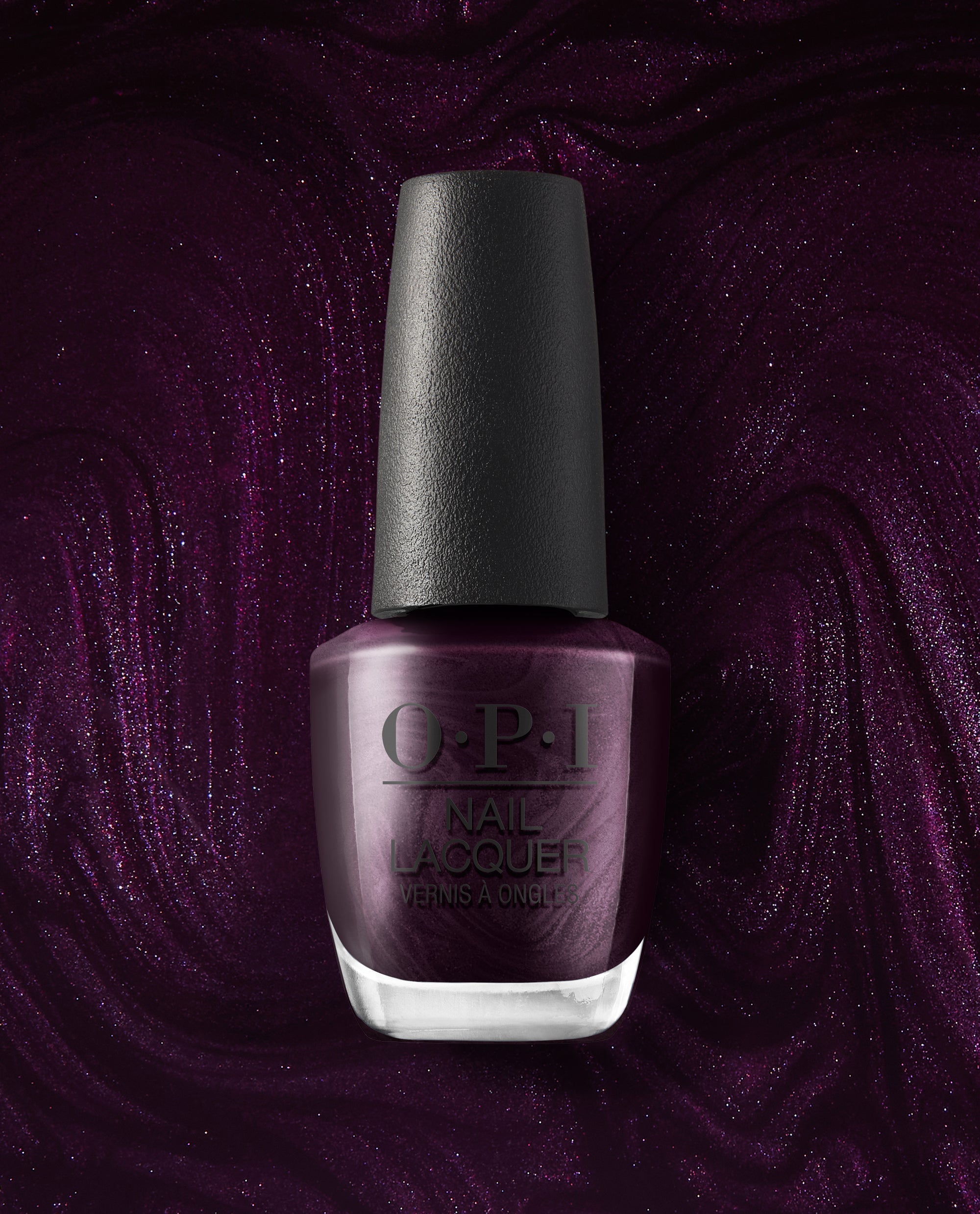 OPI Lincoln Park at Midnight nail lacquer bottle stands upright against a shimmering deep plum polish background, showcasing a dark purple metallic shade for fall nail colors.