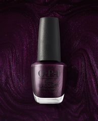 OPI Lincoln Park at Midnight nail lacquer bottle stands upright against a shimmering deep plum polish background, showcasing a dark purple metallic shade for fall nail colors.