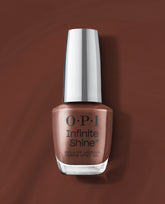 OPI Infinite Shine Lip Hot Liner gel-like lacquer bottle in a warm rosy brown shade, shown upright on a matching brown background for fall nail colors.