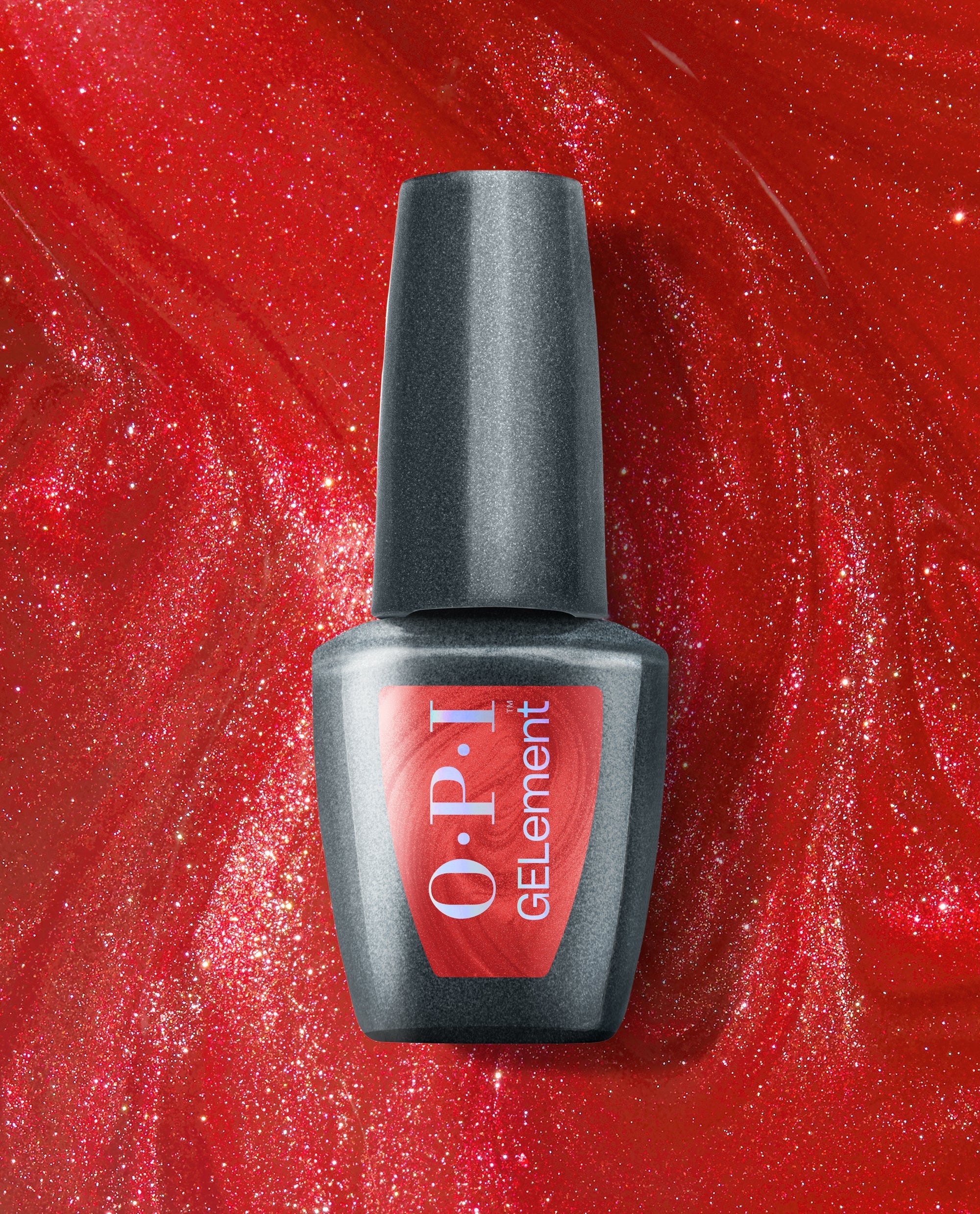 OPI Loves Me, Loves Me Hot at-home gel nail polish bottle stands against a sparkling red shimmer background, showcasing a bold red shade for fall nail colors.