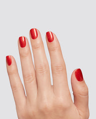 Fingernails display OPI Loves Me, Loves Me Hot at-home gel nail polish, a glossy red shimmer shade for fall nail colors, on a hand against a light gray background.