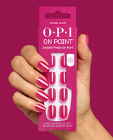 Hand with glossy fuchsia nails holds OPI On Point Malaga Glaze Instant Press-On Mani pack with matching pink press-on nails, up to 14 days wear, against a magenta background for bold fall nail colors.