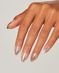 Hand with neatly manicured oval nails showcases Metallic Composition OPI nail polish, a shimmering rose-gold nail lacquer, against a clean neutral background for a sleek, modern look.