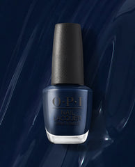 OPI nail polish bottle of Midnight Mantra nail lacquer standing upright, showcasing a rich, glossy midnight navy blue shade against a matching swirled blue background, highlighting the deep, salon-quality color for manicures and pedicures.