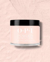 OPI Powder Perfection Mod About You Pastel dipping powder jar with a glossy black lid sits on a pale pink textured surface, showcasing a soft pink shade for fall nail colors.