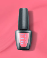 OPI MVPink at-home gel nail polish bottle standing upright, featuring a bright pink GELElement label on a sleek charcoal gray bottle, set against a matching vivid pink background, ideal for an OPI nail polish gift set.
