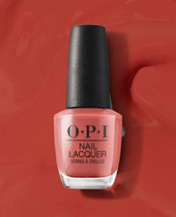 OPI nail polish bottle of My Solar Clock is Ticking coral nail lacquer standing upright on a matching glossy red-orange background, showcasing the shade’s warm, sunset-inspired color for manicures and pedicures.