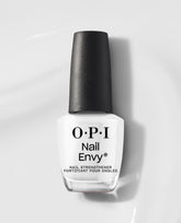 OPI Nail Envy Alpine Snow Nail Strengthener bottle in opaque white with a textured black cap, standing on a glossy white surface for trending nail treatments and strengtheners.