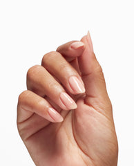 Hand with neatly manicured nails coated in a soft pink, glossy finish, showcasing the OPI Nail Envy Bubble Bath Nail Strengthener treatment, ideal as a strengthening polish or nail polish gift set against a clean white background.