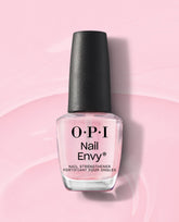 OPI Nail Envy Pink To Envy Nail Strengthener bottle standing upright, showcasing its sheer pink treatment formula and black cap on a glossy pastel pink background, perfect addition to an OPI nail polish gift set.