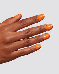 Hand modeling glossy bright orange OPI Peel Good Factor at-home gel nail polish on short rounded nails against a light gray studio background.