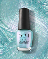 OPI nail polish bottle of Pisces the Future nail lacquer standing upright, showing its iridescent seafoam teal shimmer against a swirling, glittery turquoise backdrop for a dreamy, ocean-inspired manicure look.